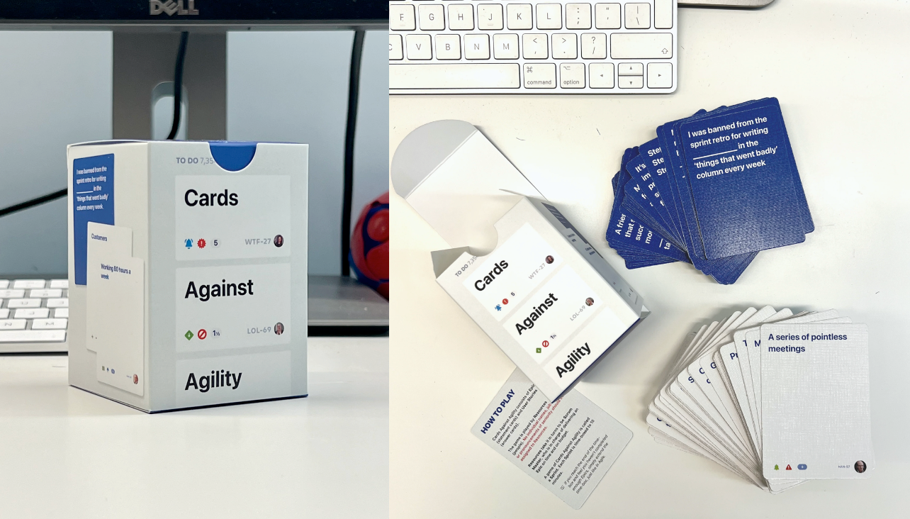 Photo of the Card Against Agility card game, on a desk next to a computer keyboard.