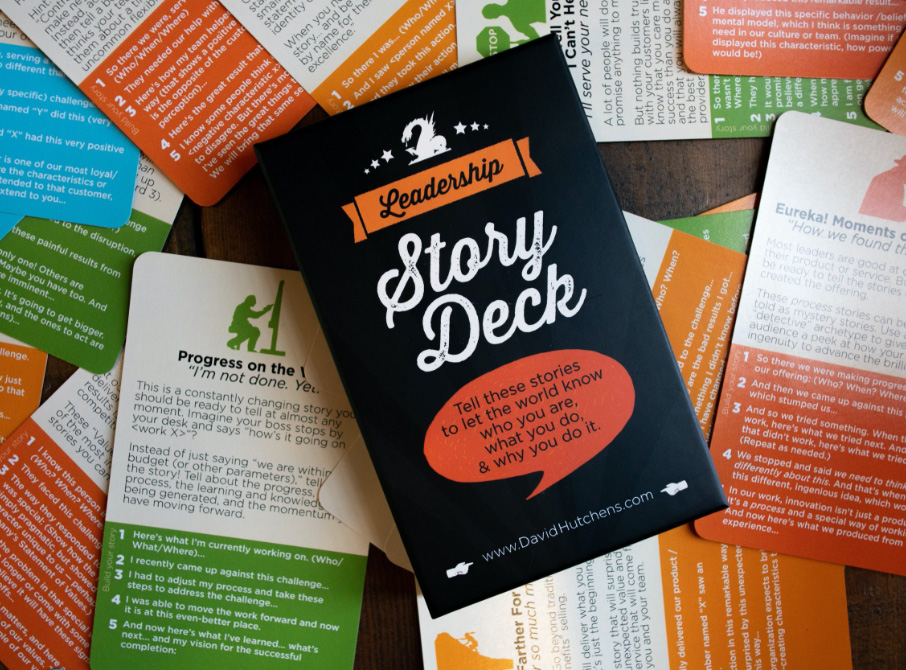 Hero shot of the Leadership Story Deck. Pictured is a copy of the box, sitting atop scattered cards from the card deck.