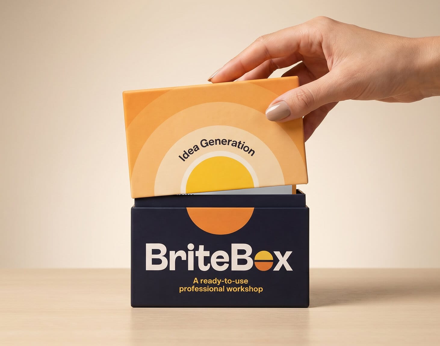 A product photograph showing a hand opening the BriteBox Idea Generation card deck. The tagline reads: 'A ready-to-use professional workshop'.